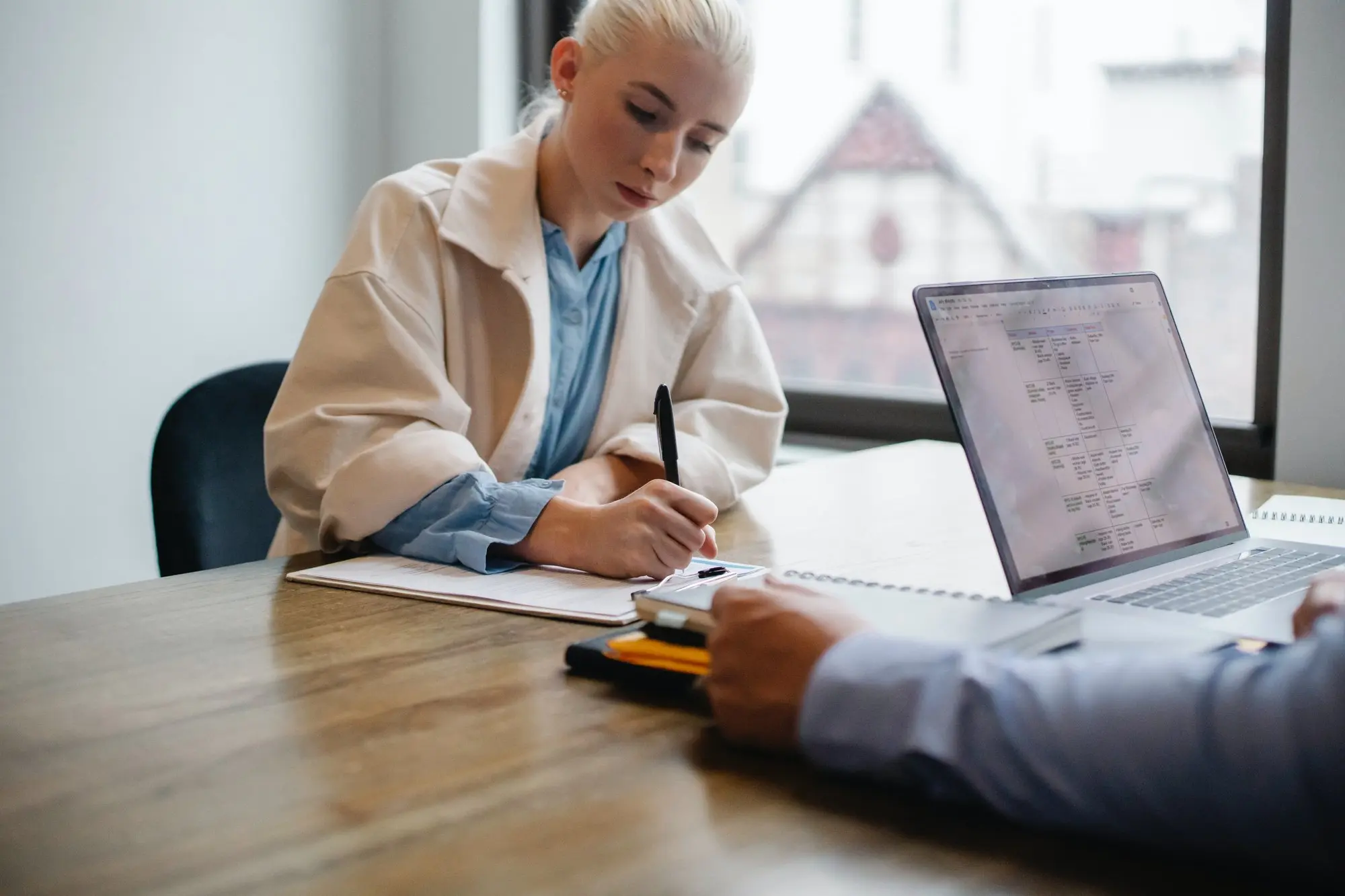 woman signing documents